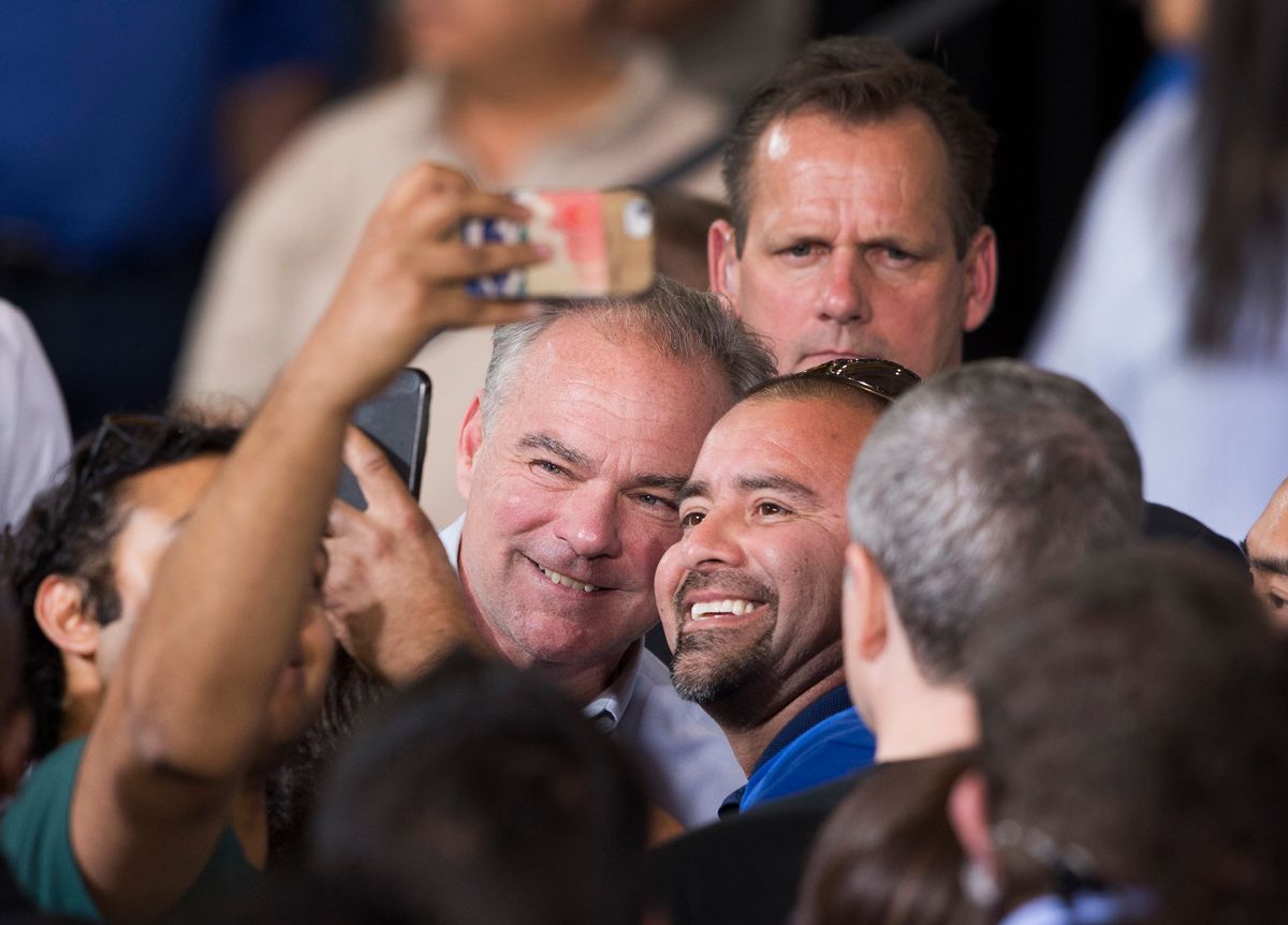 Democratic vice presidential nominee, Tim Kaine, center left, poses with a supporter during a Nevada Democratic Party rally at the Carpenters International Training Center in Las Vegas, Thursday, Oct. 6, 2016. (Steve Marcus/Las Vegas Sun via AP) (Steve Marcus/Las Vegas Sun via AP)