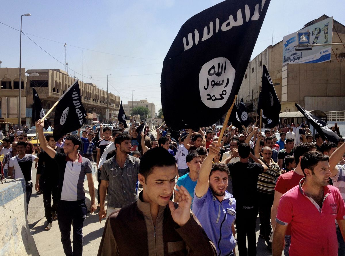 FILE - In this June 16, 2014. file photo, demonstrators chant pro-Islamic State group slogans as they carry the group's flags in front of the provincial government headquarters in Mosul, Iraq.  (AP)