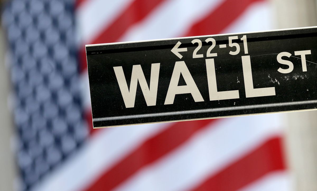 In this Tuesday, Sept. 8, 2015, file photo, a Wall Street street sign is framed by an American flag hanging on the facade of the New York Stock Exchange.  (AP Photo/Mary Altaffer, File)