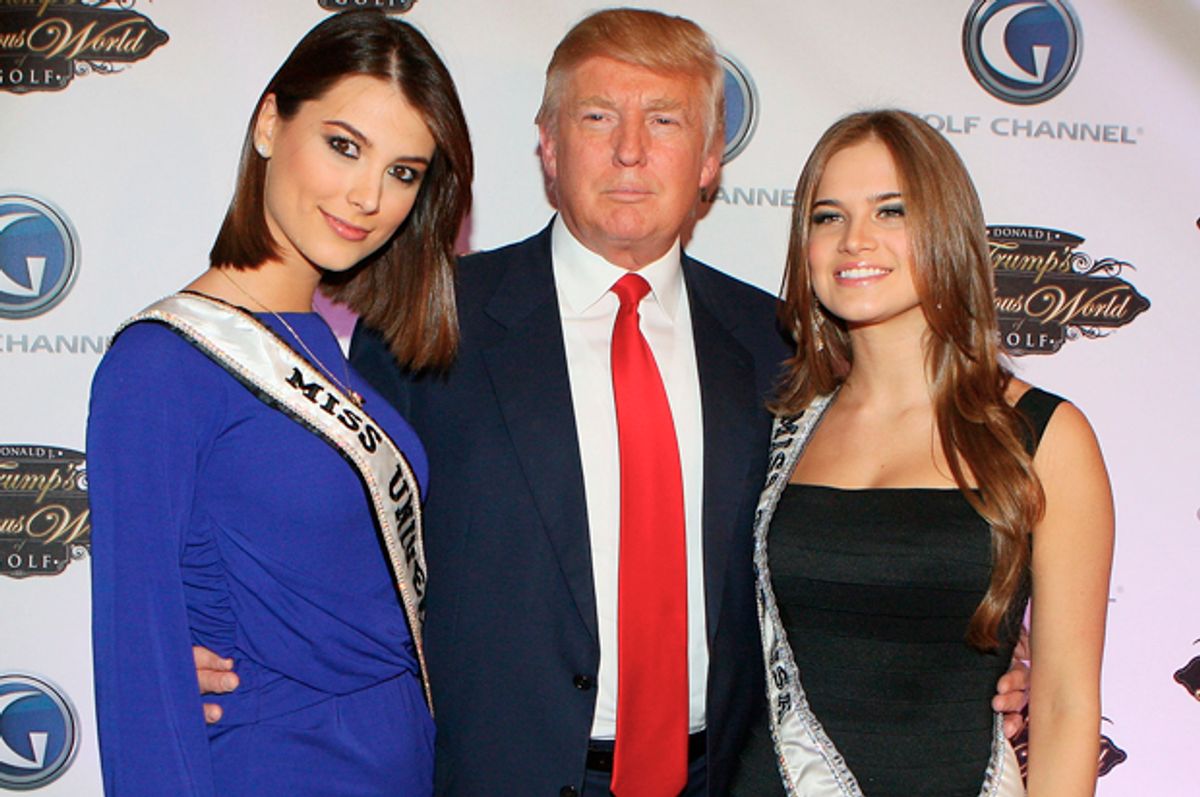 Donald Trump poses with Miss Universe Stefania Fernandez and Miss Teen USA Stormi Bree Henley at Trump Towers in New York City, March 31, 2010.   (Getty/Mike Stobe)