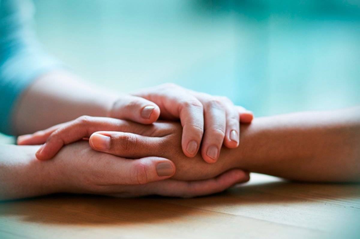 Shot of two people holding hands in comfort (Getty/PeopleImages)