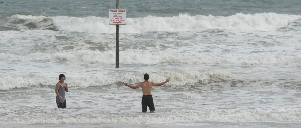 A pair of swimmers take advantage of the high surf from winds associated with Hurricane Matthew Thursday, Oct. 6, 2016, in Daytona Beach, Fla.  (AP)
