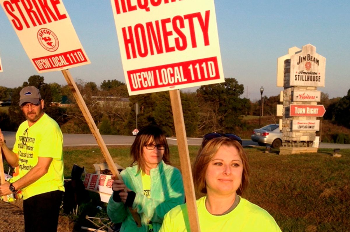 Workers hold picket signs outside the Jim Beam plant in Clermont, Ky.   (AP/Bruce Schreiner)
