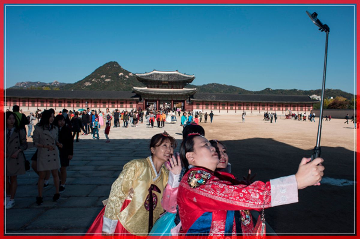 Tourists take photos as they visit Gyeongbokgung palace in Seoul on October 24, 2016. / AFP / Ed Jones        (Photo credit should read ED JONES/AFP/Getty Images) (Afp/getty Images)