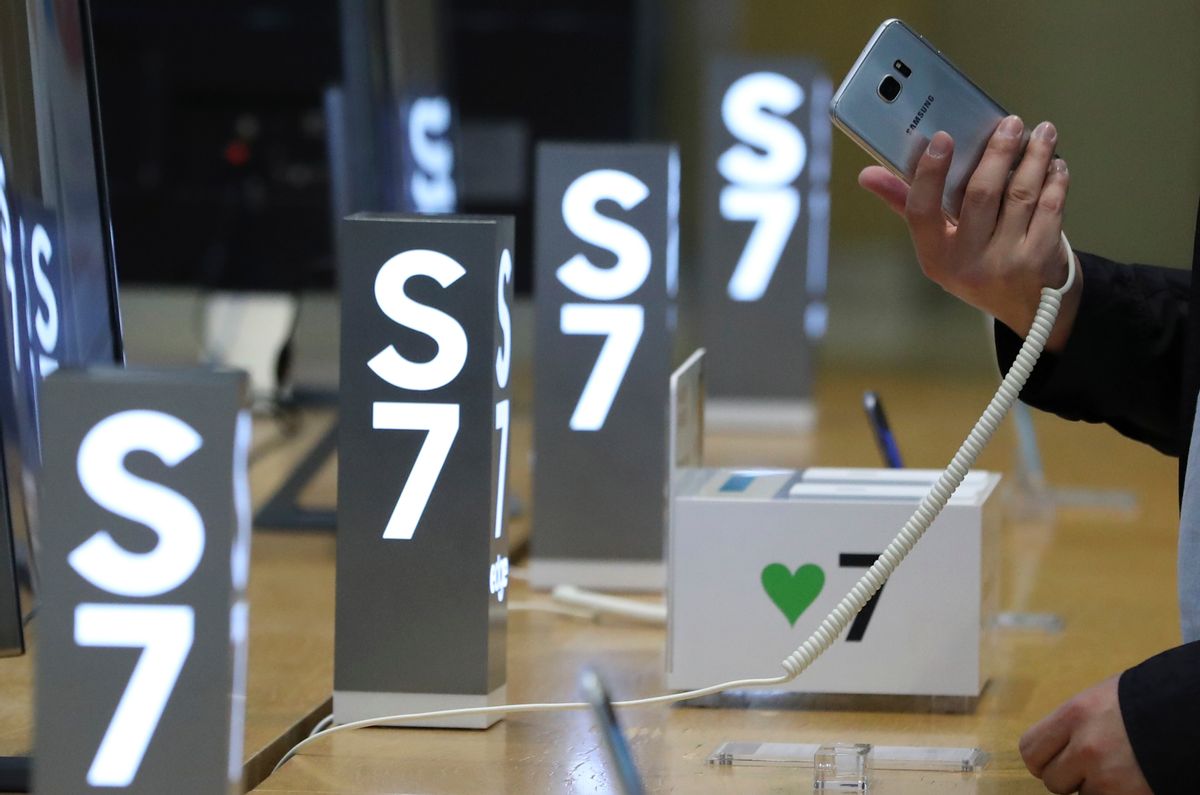 A visitor tries out a Samsung Electronics Galaxy S7 Edge smartphone at its shop in Seoul, South Korea, Friday, Oct. 14, 2016. Samsung Electronics said Friday that the discontinuation of the Galaxy Note 7 would cost the company about $3 billion during the current and next quarters, bringing the total cost of the recall to at least $5.3 billion. The company said it will expand sales of two other smartphones released in spring, the Galaxy S7 and Galaxy S7 Edge, quashing rumors that it may try to release updated versions of those devices. (AP Photo/Lee Jin-man) (AP)