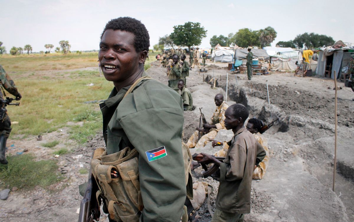 In this photo taken Sunday, Oct. 16, 2016, South Sudanese government soldiers stand in trenches in Malakal, South Sudan. Following clashes last week in the outskirts of the city, which has been reduced to rubble and almost entirely deserted by civilians, the army flew in journalists on Sunday to show that they retain control of the strategic city, even though rebels still vow to take it. (AP Photo/Justin Lynch) (AP)
