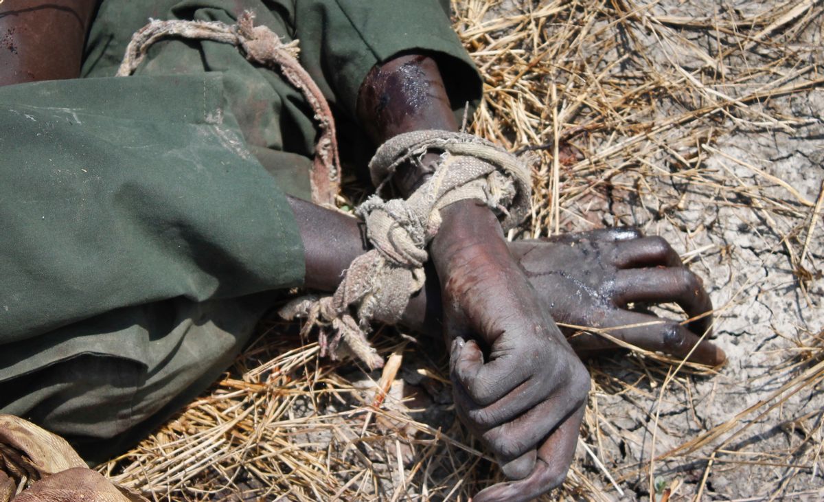 In this photo taken Sunday, Oct. 16, 2016, the body of a rebel soldier who died in a battle days before is seen with his hands tied, in Malakal, South Sudan. Following clashes last week in the outskirts of the city, which has been reduced to rubble and almost entirely deserted by civilians, the army flew in journalists on Sunday to show that they retain control of the strategic city, even though rebels still vow to take it. (AP Photo/Justin Lynch) (AP)