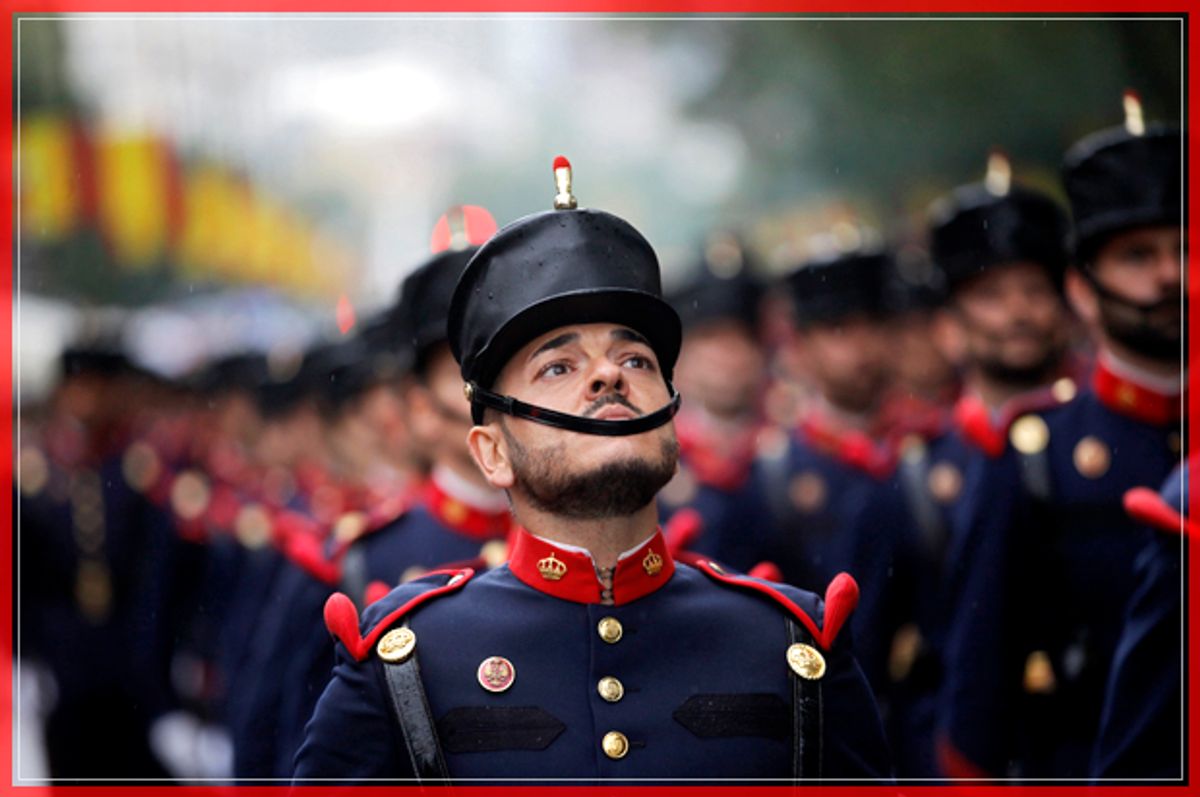 A Spanish soldier looks up as he marches with others in a military parade during a national holiday known as "Dia de la Hispanidad" or Hispanic Day, in Madrid, Spain, Wednesday, Oct. 12, 2016. Almost a year into Spain's political deadlock, the country is celebrating its National Day with a military parade of over 3,000 soldiers marching through Madrid and aircraft drawing trails of red and yellow smoke in the sky to represent the flag. (AP Photo/Francisco Seco) (AP)
