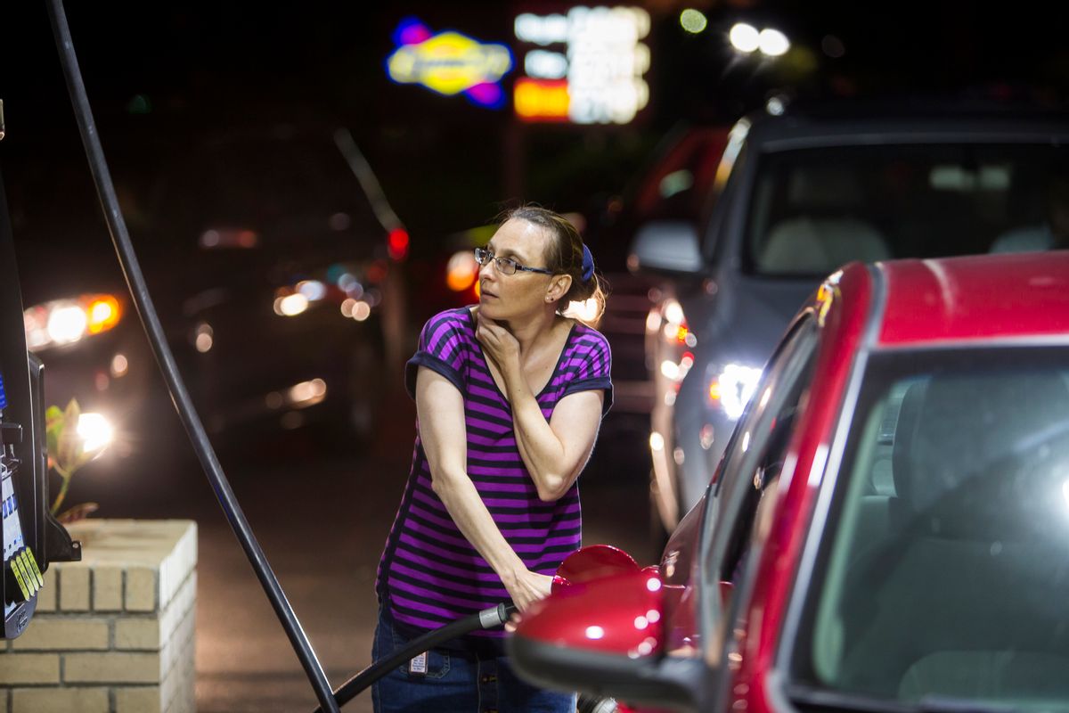 Beth Johnson fills up her car after waiting in line at a Sunoco gas station  in advance of Hurricane Matthew in Mt. Pleasant, S.C., Tuesday, Oct. 4, 2016. Hurricane Matthew is expected to affect the South Carolina coast by the weekend. Gov. Nikki Haley announced Tuesday that, unless the track of the storm changes, the state will issue an evacuation order Wednesday to help get 1 million people inland from the coast.  (AP Photo/Mic Smith) (AP)