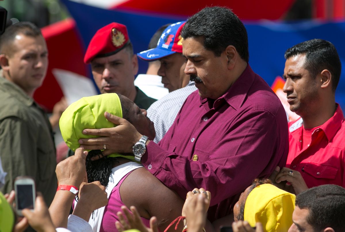 Venezuela's President Nicolas Maduro listens to a supporter during a rally outside Miraflores presidential palace in Caracas, Venezuela, Friday, Oct. 28, 2016. For the most part, residents of Venezuela's capital ignored calls to stay home Friday to protest Maduro, handing a rare victory to the embattled leader. (AP Photo/Ariana Cubillos) (AP)