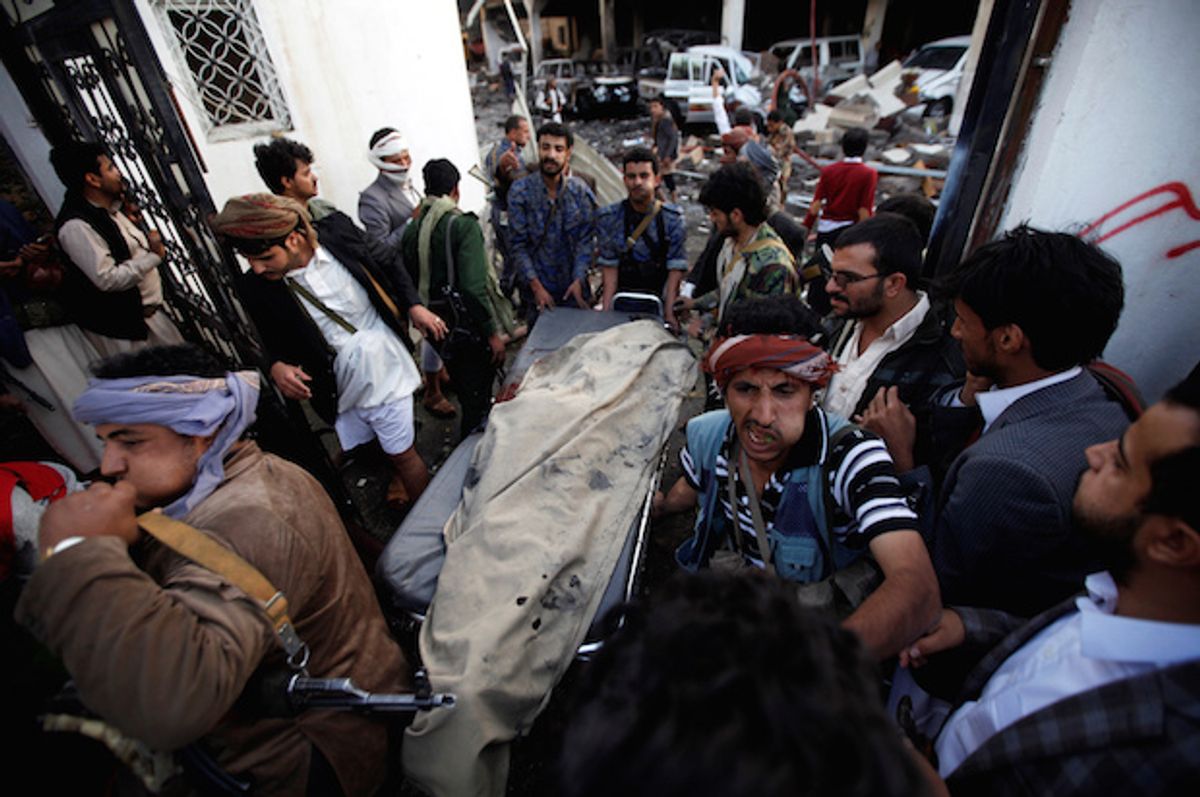 Yemenis carry the body of a man killed in a Saudi-led coalition airstrike on mourners at a funeral hall in Sana'a, Yemen on Saturday, October 8, 2016  (Reuters/Khaled Abdullah)