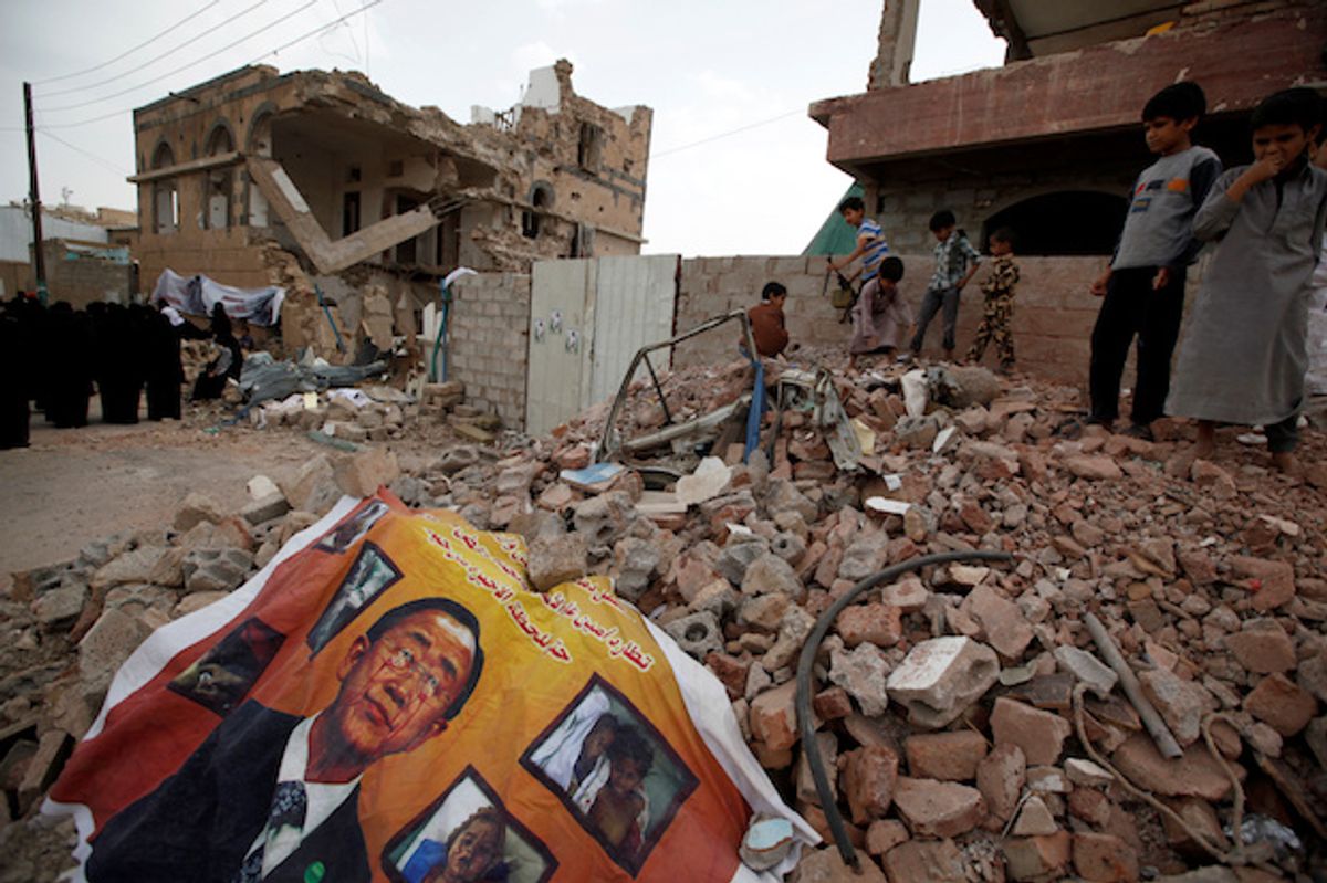 A defaced poster of the U.N. Secretary-General Ban Ki-moon on the rubble of a house during a vigil marking one year since a Saudi-led airstrike on a residential area in Yemens capital Sana'a, June 21, 2016  (Reuters/Khaled Abdullah)