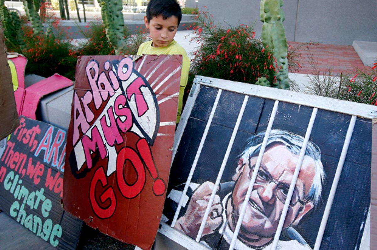 A protester stands with his sign during a rally in front of the Maricopa County Sheriff's Office Headquarters   (AP/Ross D. Franklin)