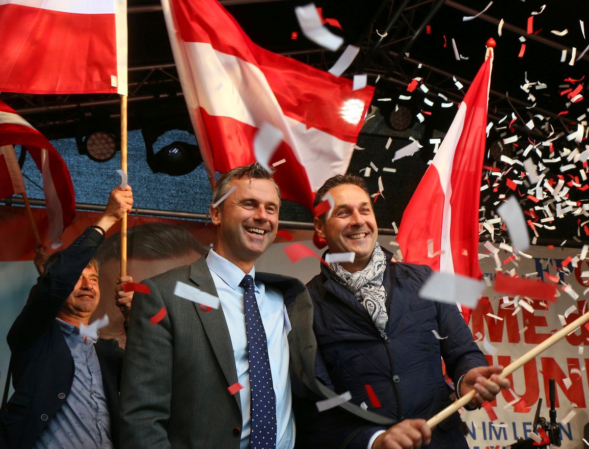FILE - In this May 20, 2016 file photo Norbert Hofer candidate for presidential elections of Austria's Freedom Party, FPOE, and Heinz-Christian Strache, from left, head of Austria's Freedom Party, FPOE, look out at supporters during the final election campaign event in Vienna.  Austrians are choosing Sunday, Dec. 4, 2016 between a moderate and a populist for president _ and both candidates are hoping to exploit the Trump effect in the first European Union nation facing such a choice since the U.S election. (AP Photo/Ronald Zak, file) (AP)
