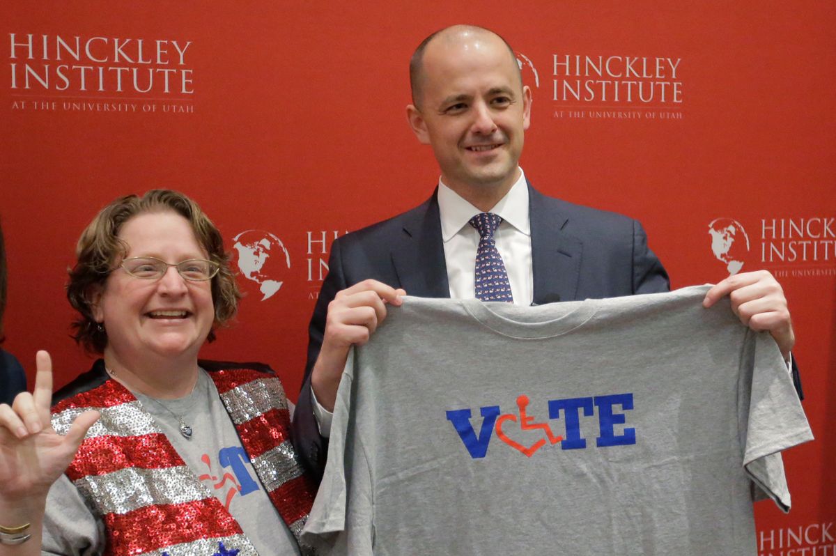 Supporter Alison Greathouse, left, poses with independent presidential candidate Evan McMullin during a University of Utah candidate forum, Wednesday, Nov. 2, 2016, in Salt Lake City. McMullin answered questions at the forum, as he attempts to fend off a new wave of critiques from Republican Donald Trump's supporters who are trying to prevent McMullin from winning what has become a toss-up state.(AP Photo/Rick Bowmer) (AP)