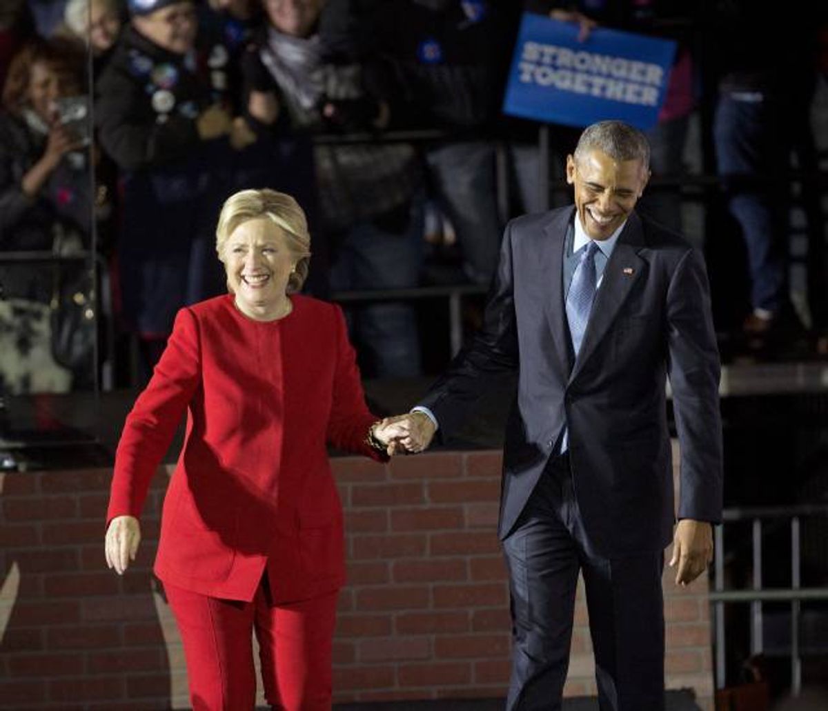 President Barack Obama and Democratic presidential candidate Hillary Clinton hold hands as they walk off stage after both spoke at a rally at Independence Mall in Philadelphia. Monday, Nov. 7, 2016 (AP Photo/Pablo Martinez Monsivais)
