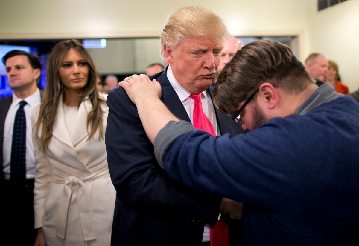 FILE - In this Jan. 31, 2016, file photo, Pastor Joshua Nink, right, prays for Republican presidential candidate Donald Trump, as his wife, Melania, left, watches after a Sunday service at First Christian Church, in Council Bluffs, Iowa.  (AP)