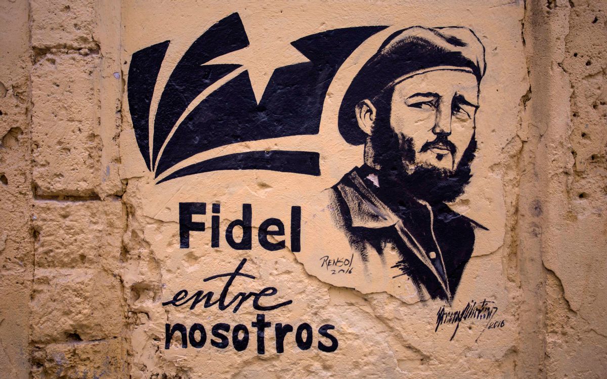 A stencil graffiti featuring Fidel Castro's image says in Spanish "Fidel among us," in an alleyway in Havana, Cuba, Sunday, Nov. 27, 2016.  (AP)