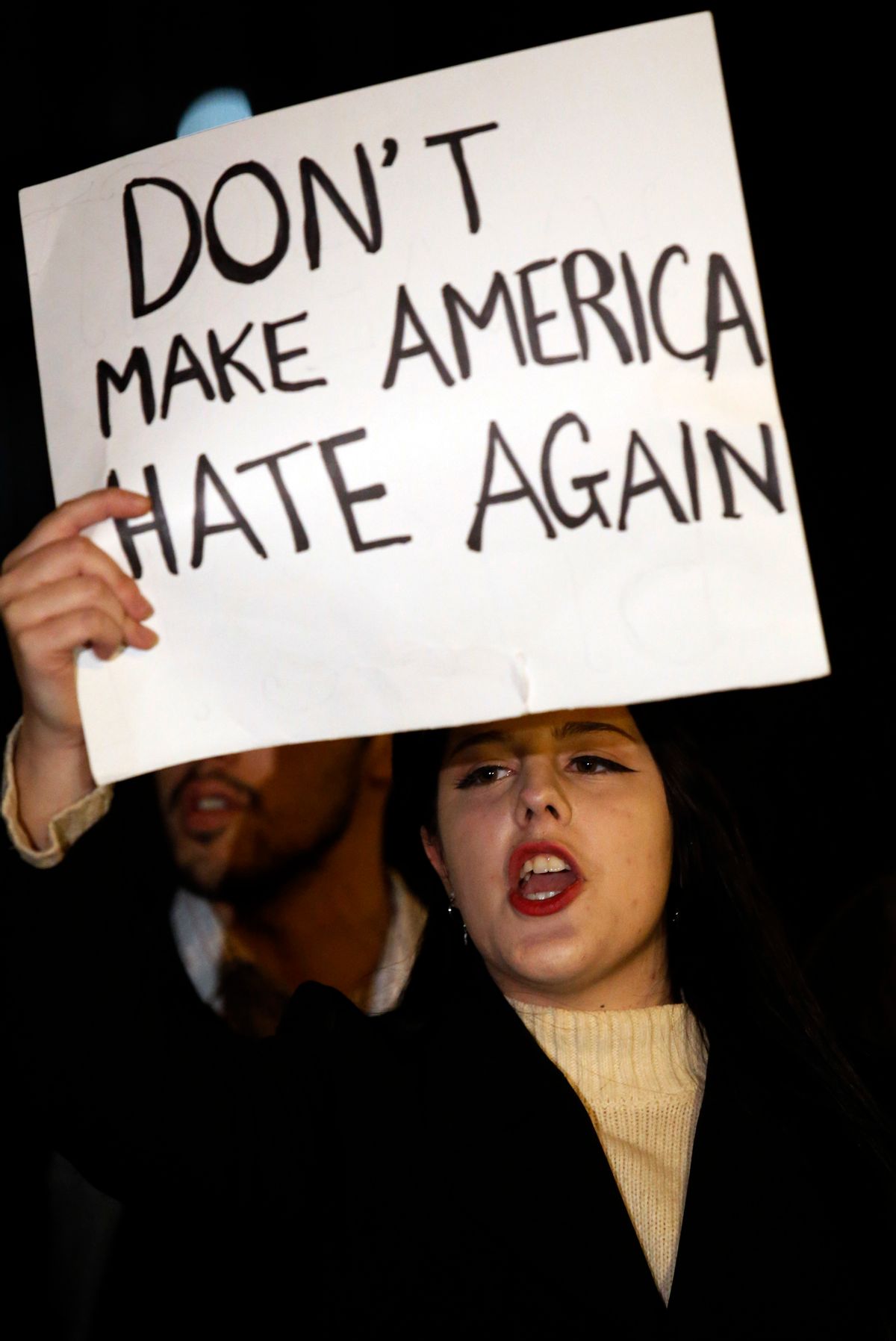 A protester holds a sign during a protest against the election of President-elect Donald Trump in Chicago, Thursday, Nov. 10, 2016. Two days after Trump's election as president, the divisions he exposed only showed signs of widening as many thousands of protesters flooded streets across the country to condemn him. (AP Photo/Nam Y. Huh) (AP)