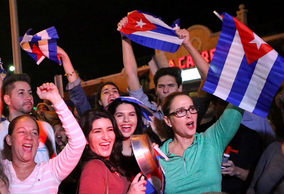 FILE- In this Nov. 25, 2016, file photo, the Cuban community in Miami celebrates the announcement that Fidel Castro died in front La Carreta Restaurant early in Miami. For the hundreds of thousands of children born of Cuban exiles, some who are two and three generations removed from the island, Fidel Castro’s death potentially opens a door to a world previously off-limits. (David Santiago/El Nuevo Herald via AP, File) (AP)