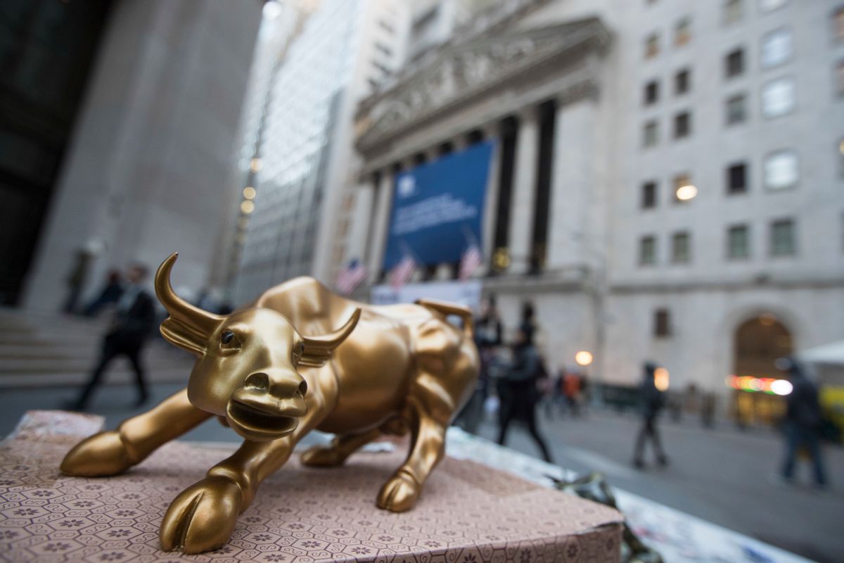 In this Tuesday, Oct. 25, 2016, photo, a miniature reproduction of Arturo Di Modica's "Charging Bull" sculpture sits on display at a street vendor's table outside the New York Stock Exchange, in lower Manhattan.  Global stock markets were mixed on Wednesday, Nov. 16, 2016,  as investors awaited more policy details from U.S. President-elect Donald Trump. Oil prices retreated, snapping an overnight rally. (AP Photo/Mary Altaffer) (AP)