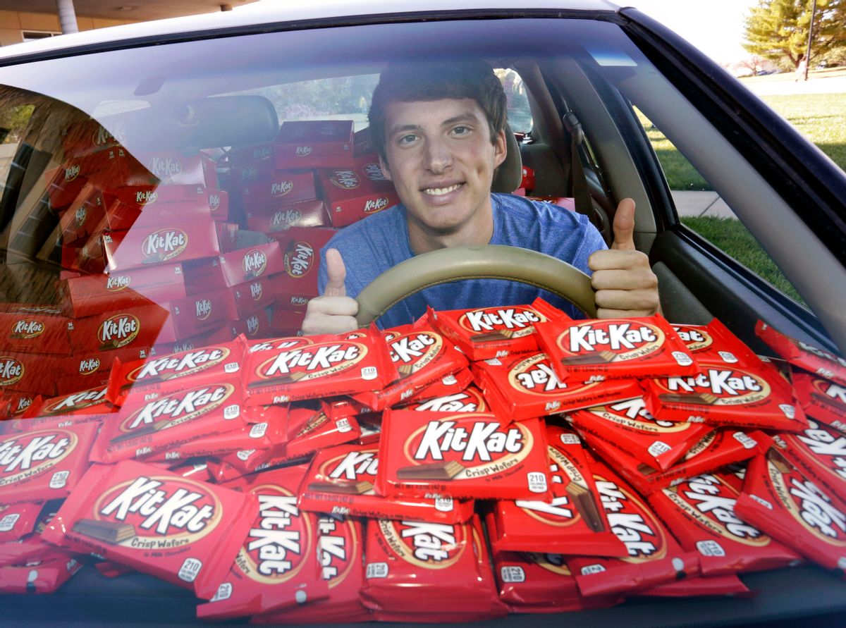 In this Nov. 3, 2016, photo Hunter Jobbins, freshman at Kansas State University, poses in his car filled with nearly 6,500 Kit Kat bars in Manhattan, Kansas. Jobbins told The Wichita Eagle he left his car unlocked with a Kit Kat in the cupholder last month before running into his dorm building. When he came back, the candy bar had been replaced with a note. The thief wrote, “I love Kit Kats so I checked your door and it was unlocked. Did not take anything other than the Kit Kat. I am sorry and hungry.” Jobbins’ picture of the note went viral on Twitter and Hershey responded by sending a representative to the campus with 6,500 Kit Kat bars. (Colin E. Braley/AP Images for The Hershey Company) (AP)