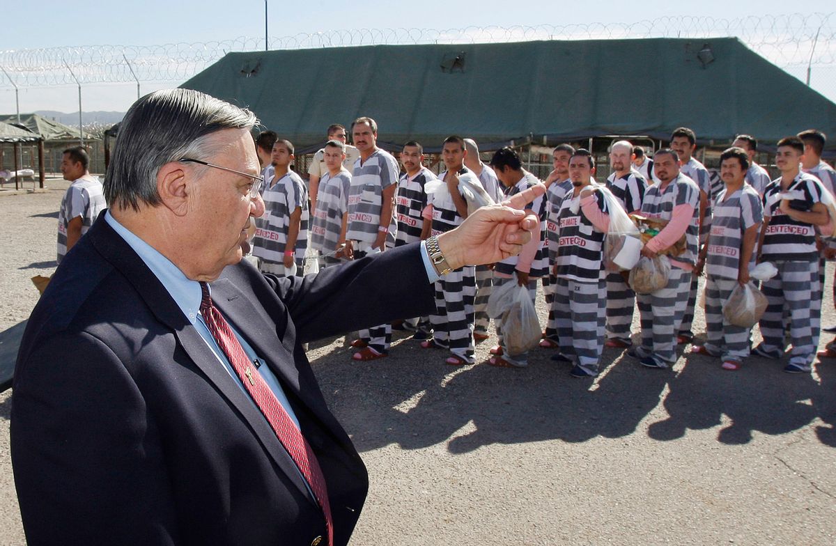FILE - In this Feb. 4, 2009 file photo, Maricopa County Sheriff Joe Arpaio, left, orders approximately 200 convicted illegal immigrants handcuffed together and moved into a separate area of Tent City, for incarceration until their sentences are served and they are deported to their home countries, in Phoenix. Arpaio became a national political figure by taking on duties that none of his counterparts would ever touch, jailing inmates in tents, making them wear pink underwear, leading immigration crackdowns and investigating President Barack Obama's birth certificate.  (AP Photo/Ross D. Franklin, File)