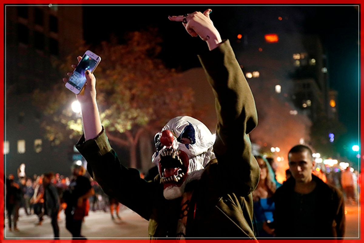 A masked demonstrator gestures toward a police line during a demonstration in Oakland, California, U.S. following the election of Donald Trump as President of the United States November 9, 2016. REUTERS/Stephen Lam - RTX2SXVM (Reuters)