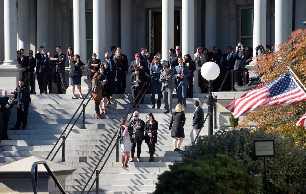 People stand on the steps of the Eisenhower Executive Office Building, next to the White House in Washington, Thursday, Nov. 10, 2016, as they wait for the arrival of President-elect Donald Trump for his meeting with President Barack Obama. (AP Photo/Susan Walsh) (AP)