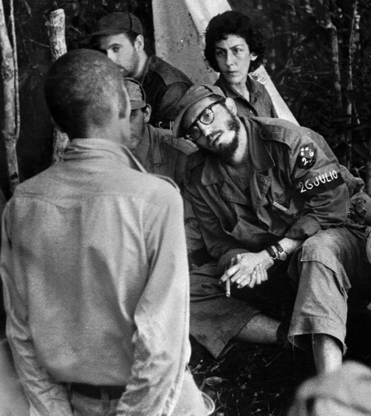 FILE - In this 1958 file photo, Cuba's leader Fidel Castro, center, questions a man charged with banditry as Celia Sanchez looks on during a trial held in the guerrillas' base in the Cuban mountain range of Sierra Maestra.  (AP)