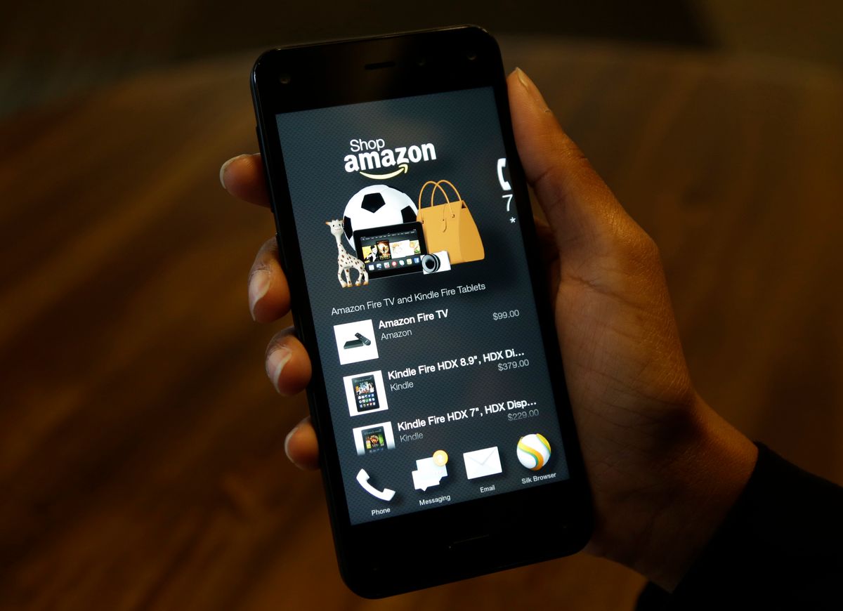 FILE - This June 18, 2014, file photo shows the app that links to shopping on Amazon.com on an Amazon Fire Phone, in Seattle. If you’re looking to save a few bucks at the mall, there are apps available that can help find you coupons, compare prices or price match. (AP Photo/Ted S. Warren, File) (AP)