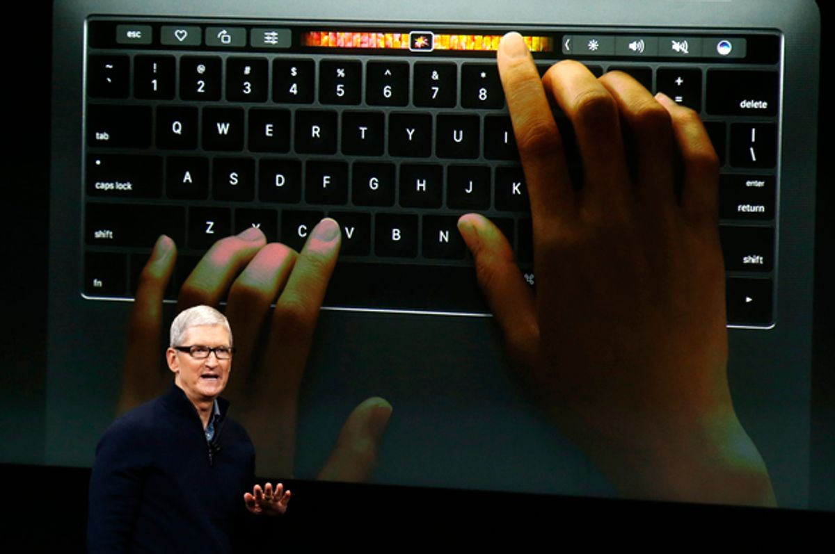 Tim Cook speaks under a graphic of the new MacBook Pro at an Apple media event in Cupertino, California, October 27, 2016.   (Reuters/Beck Diefenbach)