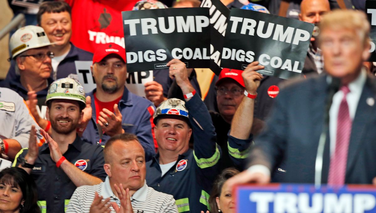 FILE- In this May 5, 2016 photo, Coal miners wave signs as Republican presidential candidate Donald Trump speaks during a rally in Charleston, W.Va. Trump's election could signal the end of many of President Barack Obama's signature environmental initiatives. Trump has said he loathes regulation and wants to use more coal and expand offshore drilling and hydraulic fracturing. (AP Photo/Steve Helber, File) (AP)
