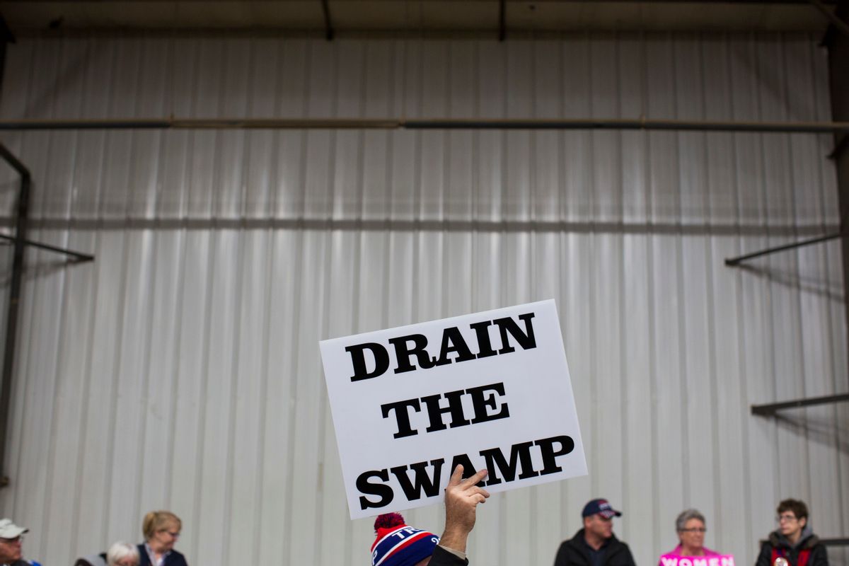 FILE - In this Oct. 27, 2016, file photo, supporters of then-Republican presidential candidate Donald Trump hold signs during a campaign rally in Springfield, Ohio. President-elect Donald Trump’s campaign promise to “drain the swamp” of Washington might make it difficult for him to fill all the jobs in his administration. () (AP Photo/ Evan Vucci, file)