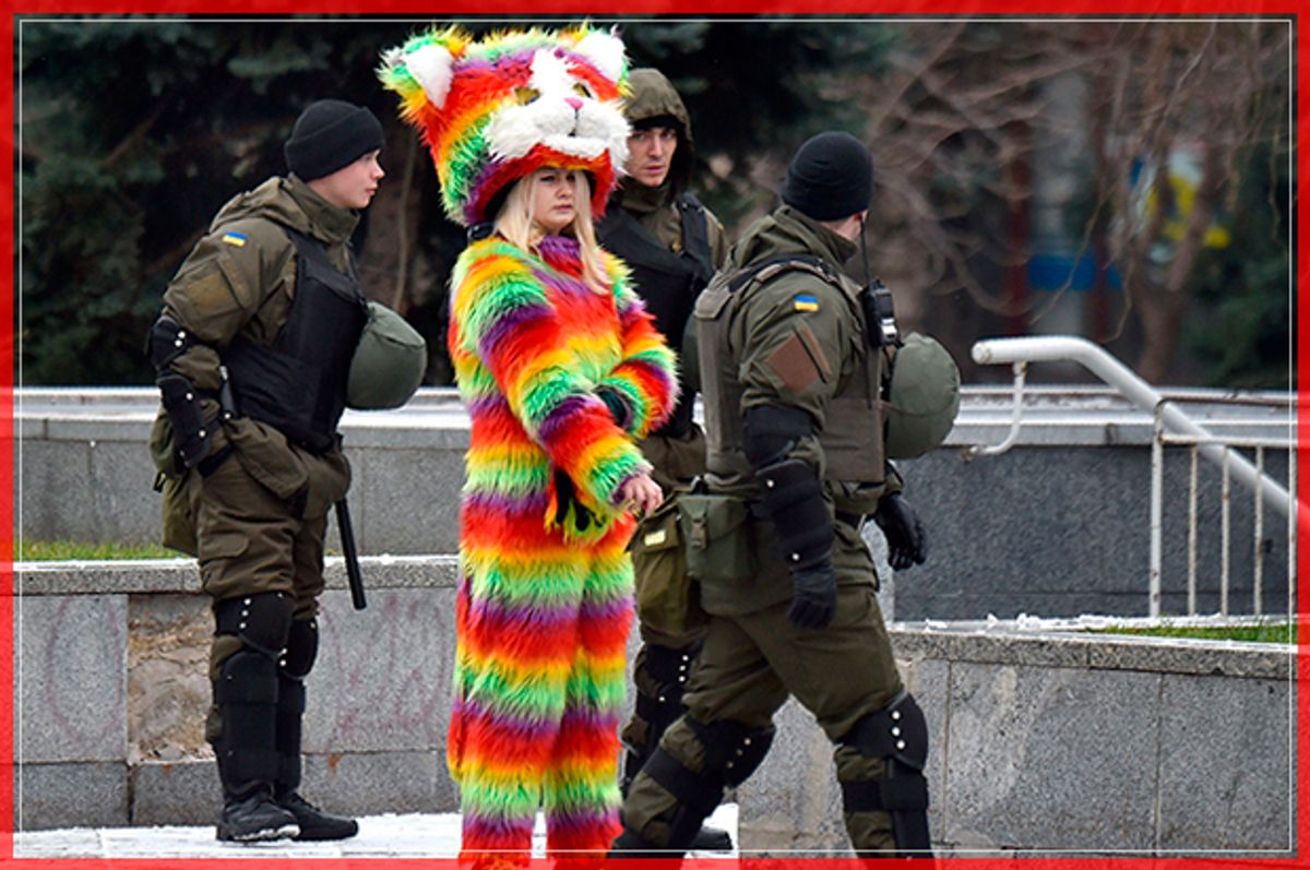 Ukrainian National Guard members walk past a woman wearing a colourful costume as they patrol near Independence Square in Kiev on November 22, 2016 following a night of violence by activists of some far-right Ukrainian parties.
Kiev police said they were investigating an attack by far-right activists on a Russian bank and the office of a Ukrainian politician who is close friends with Kremlin chief Vladimir Putin. Ukraine had marked the third anniversary of the start of three months of protests that resulted in the country's Russian-backed former president being ousted in February 2014 as the former Soviet republic set on a pro-European Union course. / AFP / Sergei SUPINSKY        (Photo credit should read SERGEI SUPINSKY/AFP/Getty Images) (Afp/getty Images)