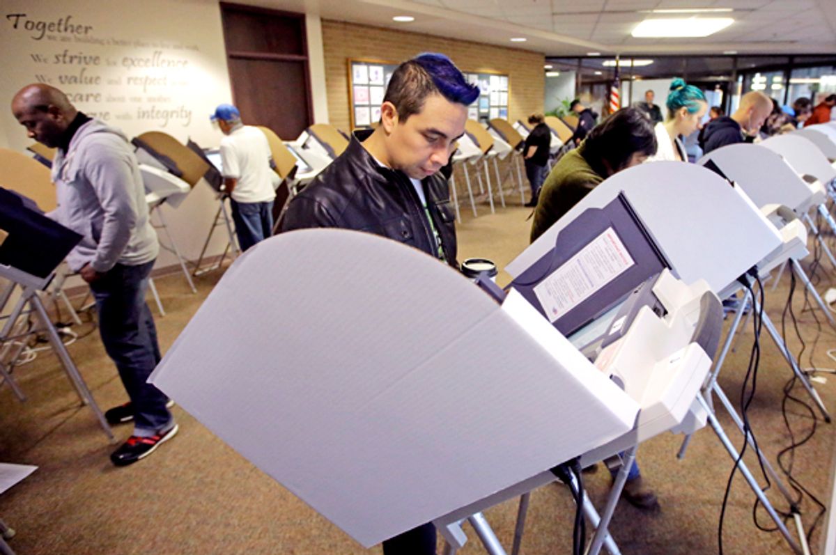 David Gonzalez, center, votes at the Salt Lake County Government Center Tuesday, Nov. 8, 2016, in Salt lake City. Utah's mostly Mormon, mostly Republican voters are going to the polls Tuesday to determine if the GOP's five-decade winning streak in presidential elections will remain intact or be snapped. (AP Photo/Rick Bowmer) (AP)