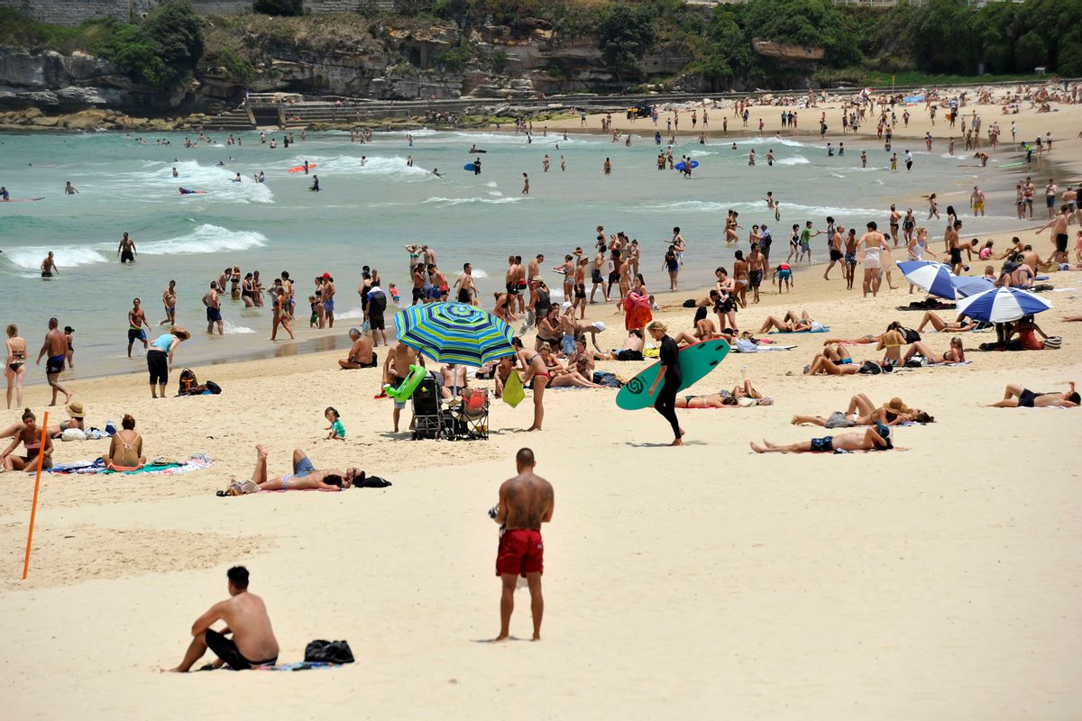 In this Tuesday, Dec. 13, 2016 photo, people gather on the sand at Bondi Beach in Sydney, Australia. Sydney residents sweltered through the city's second hottest night on record and its hottest December night in 148 years, with many cooling off at beaches long after dark. A minimum of 27.1 degrees Celsius (80.8 degrees Fahrenheit) was recorded in Australia's largest city early Wednesday, Australian Bureau of Meteorology forecaster Jordan Notara said. () (Joel Carrett/AAP Image via AP)