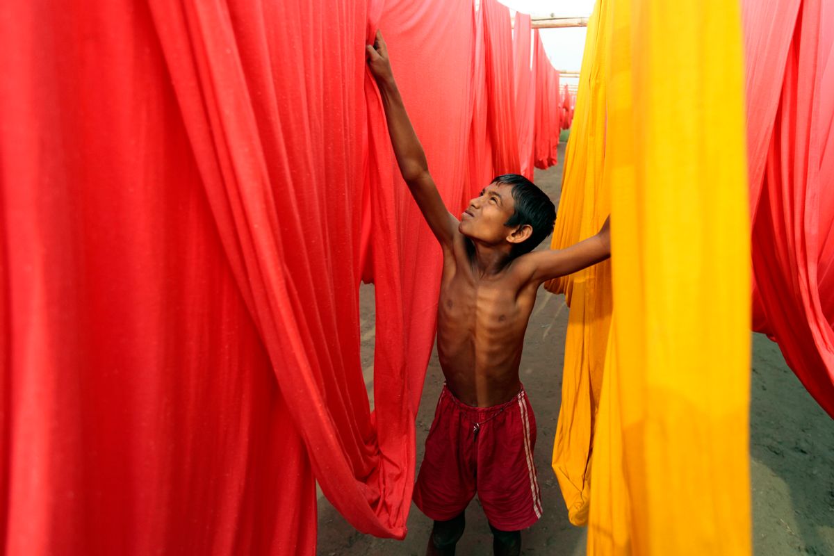 FILE- In this Saturday, Dec. 22, 2012 file photo, a Bangladeshi child works at a clothes-dyeing factory in Narayanganj, outskirts of Dhaka, Bangladesh. A new study by the London-based Overseas Development Institute found that thousands of Bangladeshi children who live in the capital's slums are working illegally for an average of 64 hours a week. (AP Photo/A.M. Ahad, File) (AP)