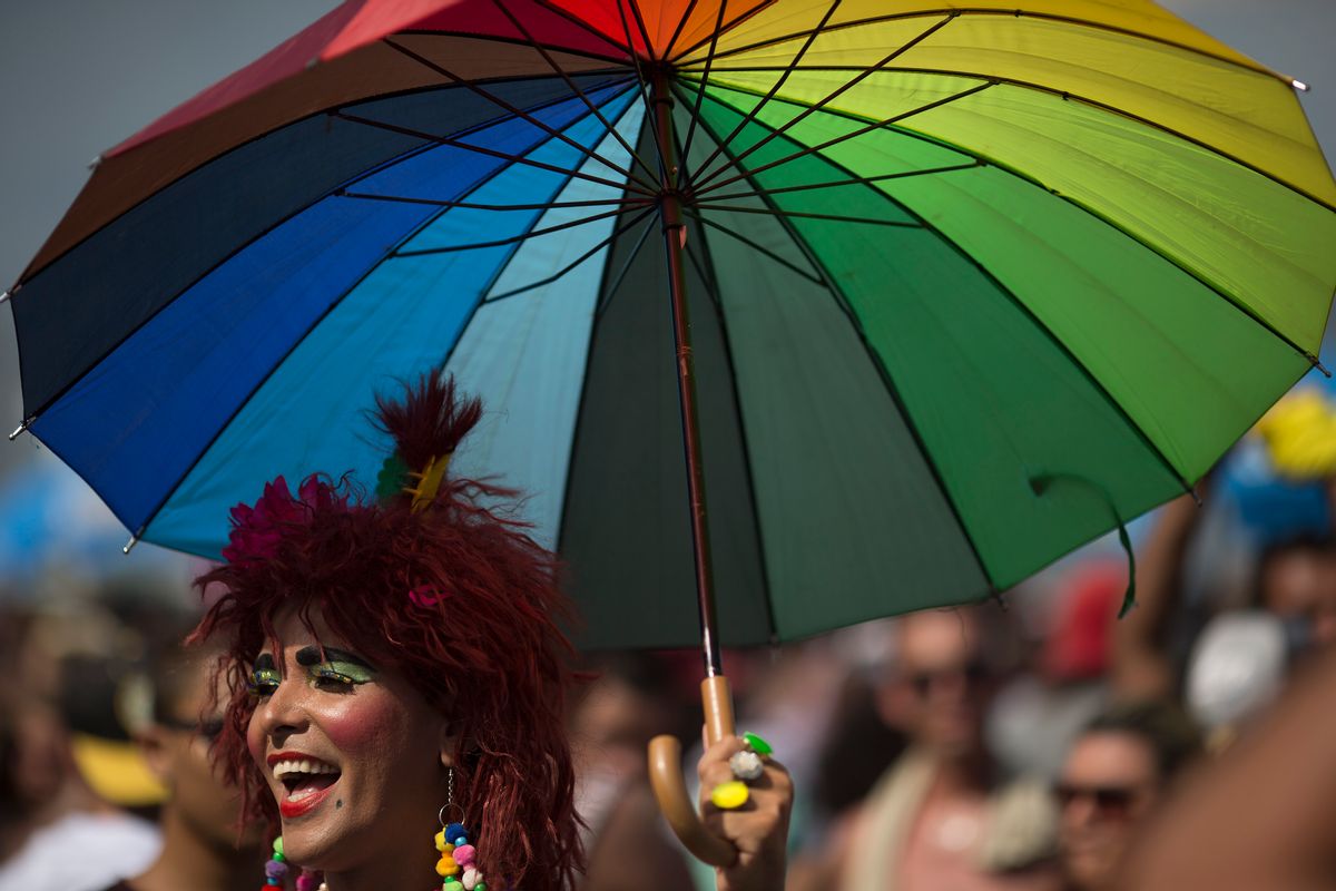 A man holds a colored umbrella as he participates in the Gay Pride Parade at Copacabana beach in Rio de Janeiro, Brazil, Sunday, Dec. 11, 2016. People took part in Rio de Janeiro's 21st Gay Pride Parade to fight for more justice and an inclusive society which recognizes equal rights for the gay community. (AP Photo/Leo Correa) (AP)