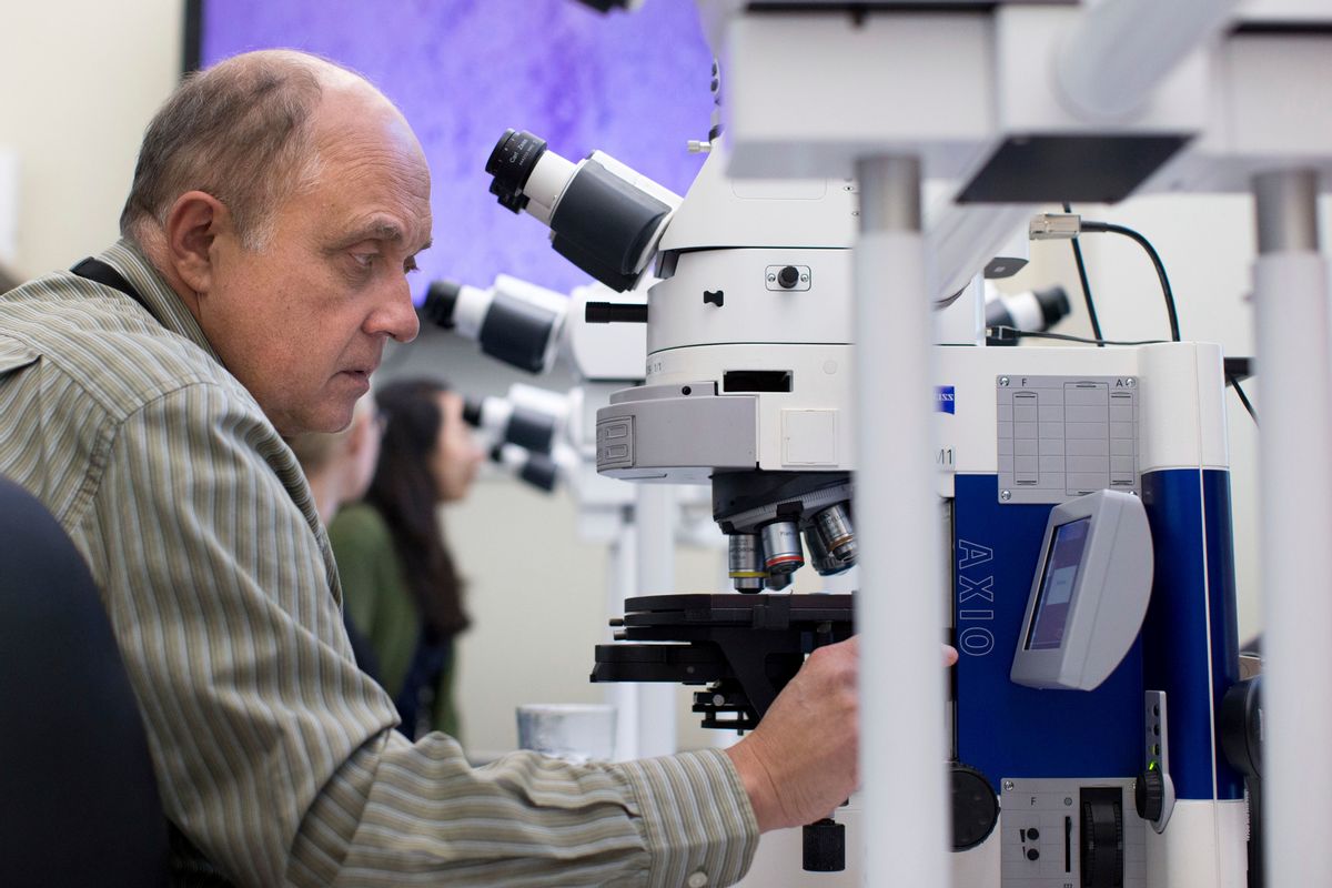 In this Thursday, Nov. 10, 2016 photo, Dr. Sherif Zaki adjusts a microscope at the Centers for Disease Control and Prevention in Atlanta. On Monday, Dec. 5, 2016, the nation's top public health agency issued a frank assessment of its recent battles against prioritized health problems, finding progress in some areas but backslide in others. Despite the mixed grades in the CDC’s report card on itself, some experts applauded CDC efforts, saying the agency had only limited abilities to prevent illness or stop people from doing things that hurt their own health. (AP Photo/Branden Camp) (AP)