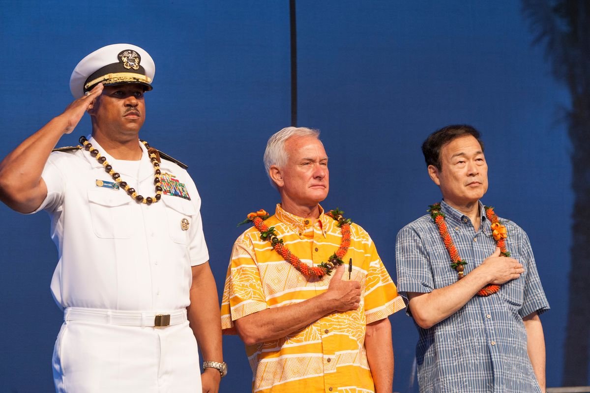 FILE - In this Aug. 15, 2015 file photo, U.S. Navy Read Adm. John Fuller, left, Honolulu mayor Kirk Caldwell, center, and then Nagaoka CityMayor Tomio Mori look on during a celebration marking the 70th anniversary of the end of World War II at Joint Base Pearl Harbor-Hickam, in Honolulu. The mayor of Nagaoka, Japan, the birthplace of the man who engineered the Pearl Harbor attack, is joining his counterpart of Honolulu to commemorate the 75th anniversary of the beginning of the four-year war between the two countries, as friends. Mayor Tatsunobu Isoda and eight other members of his delegation are formally invited as guests of Honolulu at both the main memorial on Wednesday, Dec. 7, 2016,  and a separate first ceremony Thursday, Dec. 8, co-organized by Japan and the U.S. (AP Photo/Marco Garcia, File) (AP)