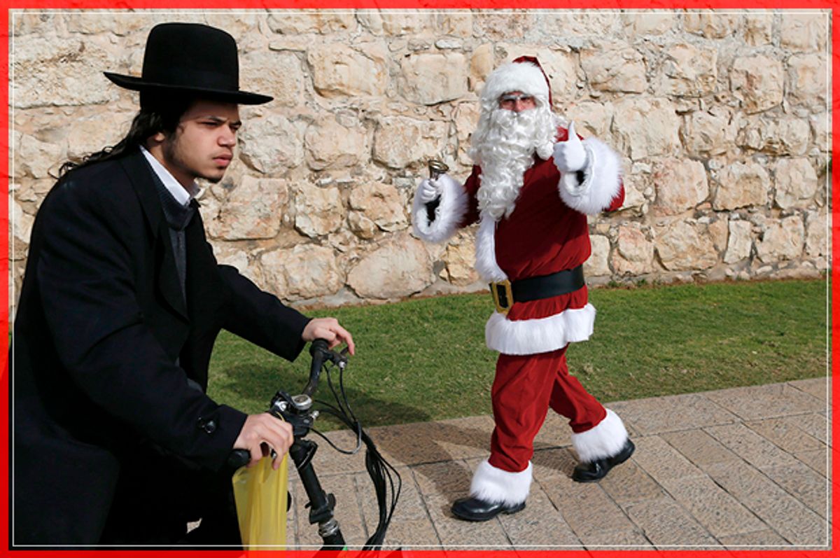 An Ultra-Orthodox Jew rides past a Palestinian man dressed up as Santa Claus outside Jaffa Gate in Jerusalem's Old City, on December 23, 2016, as Christians around the world prepare to celebrate the holy day. / AFP / AHMAD GHARABLI        (Photo credit should read AHMAD GHARABLI/AFP/Getty Images) (Afp/getty Images)