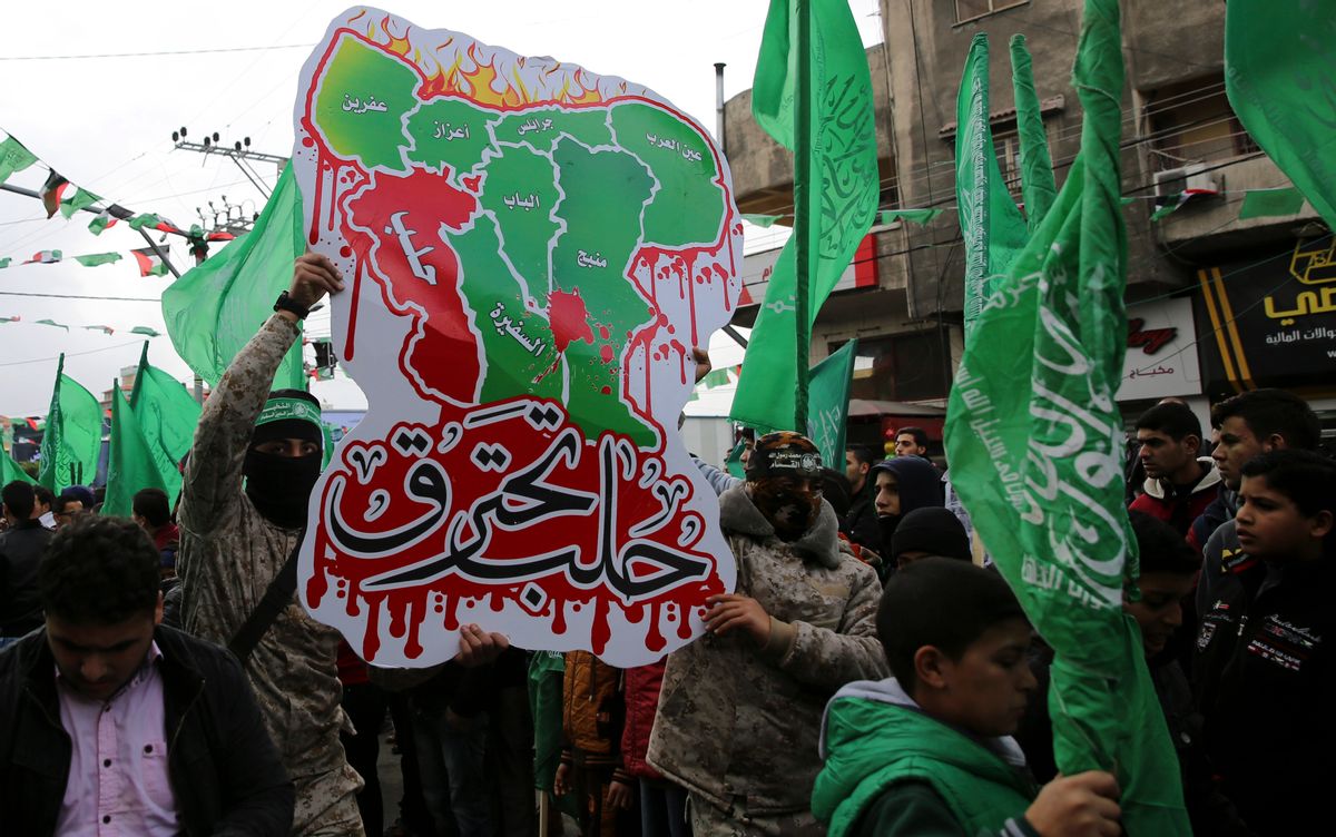 Masked Palestinian militants from the Izzedine al-Qassam Brigades, a military wing of Hamas, hold a poster of a Syrian map with Arabic text that reads, "Aleppo is burning," as others wave green Islamic flags during a rally to commemorate the 29th anniversary of its founding, in Gaza City, Wednesday, Dec. 14, 2016. Hamas overtook Gaza by force in 2007 after routing troops loyal to Palestinian President Mahmoud Abbas in bloody street battles. Palestinians have been divided since between Gaza under Hamas and Abbas governing parts of the West Bank. () (AP Photo/Adel Hana)