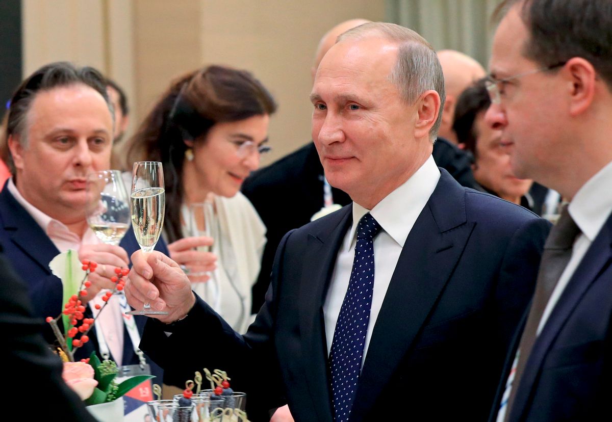 In this photo taken Friday, Dec. 2, 2016 Russian President Vladimir Putin toasts at a meeting with Russian and foreign cultural figures in the Mariinsky Theater in St. Petersburg, Russia. At right, Russian Culture Minister Vladimir Medinsky. At left back, Russia's Vakhtangov theater director Kirill Krok. (Mikhail Klimentyev/Sputnik, Kremlin Pool Photo via AP) (AP)