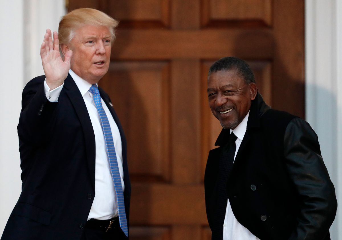 FILE - In this Nov. 20, 2016 file photo, President-elect Donald Trump stands with BET founder Robert Johnson at the Trump National Golf Club Bedminster clubhouse in Bedminster, N.J.. Johnson is one of dozens of people who have paraded into Trump’s properties in New York and New Jersey in recent weeks for job interviews and other consultations with the Republican. Several described the meetings as serious, yet conversational, with the president-elect leading the discussion and asking questions extemporaneously, without consulting notes. (AP Photo/Carolyn Kaster, File) (AP)