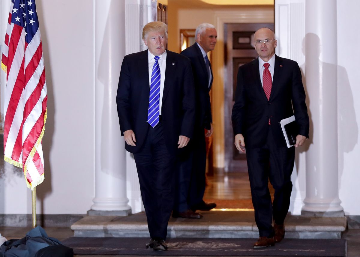 FILE - In this Nov. 19, 2016 file photo, President-elect Donald Trump walks with CKE Restaurants CEO Andy Puzder from Trump National Golf Club Bedminster clubhouse in Bedminster, N.J. Trump is expected to add another wealthy business person and elite donor to his Cabinet, with fast food executive Andrew Puzder as Labor secretary. In the background is Vice President-elect Mike Pence. (AP Photo/Carolyn Kaster) (AP)
