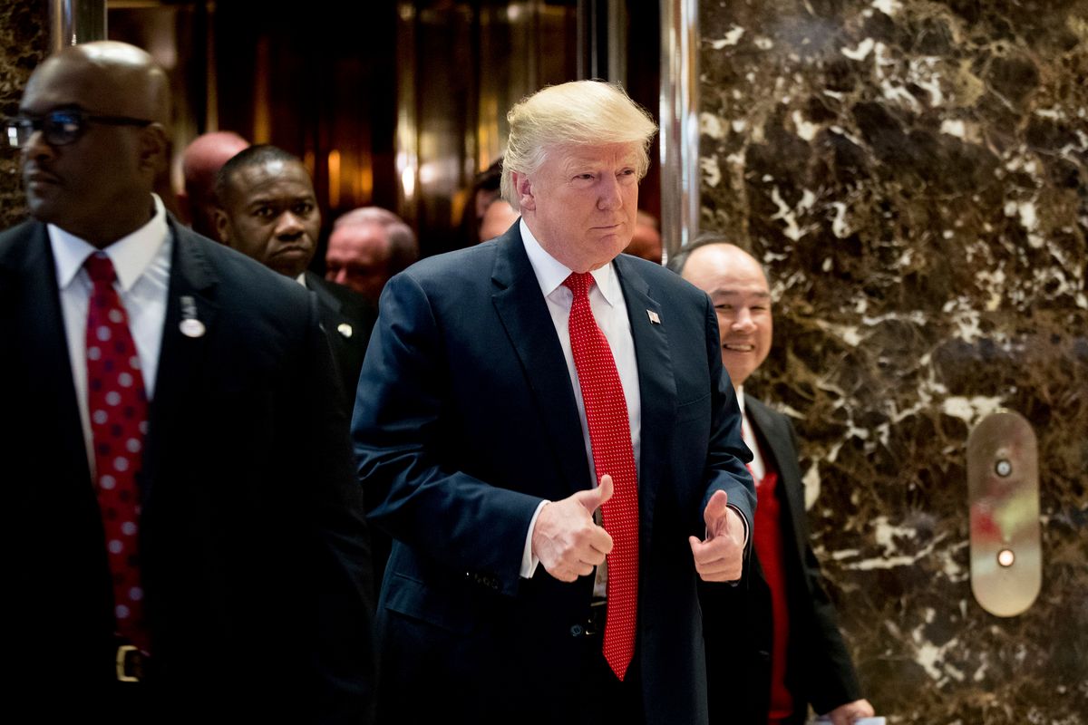 President-elect Donald Trump and SoftBank Chief Executive Officer Masayoshi Son, right, walk into the lobby to speak to members of the media at Trump Tower in New York, Tuesday, Dec. 6, 2016. (AP Photo/Andrew Harnik) (AP)