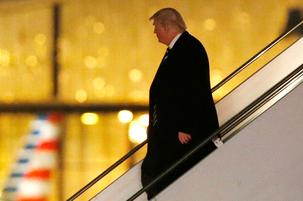 President-elect Donald Trump walks down the stairs from his plane after returning from Wisconsin to LaGuardia Airport, Tuesday, Dec. 13, 2016, in New York. (AP Photo/Kathy Willens)