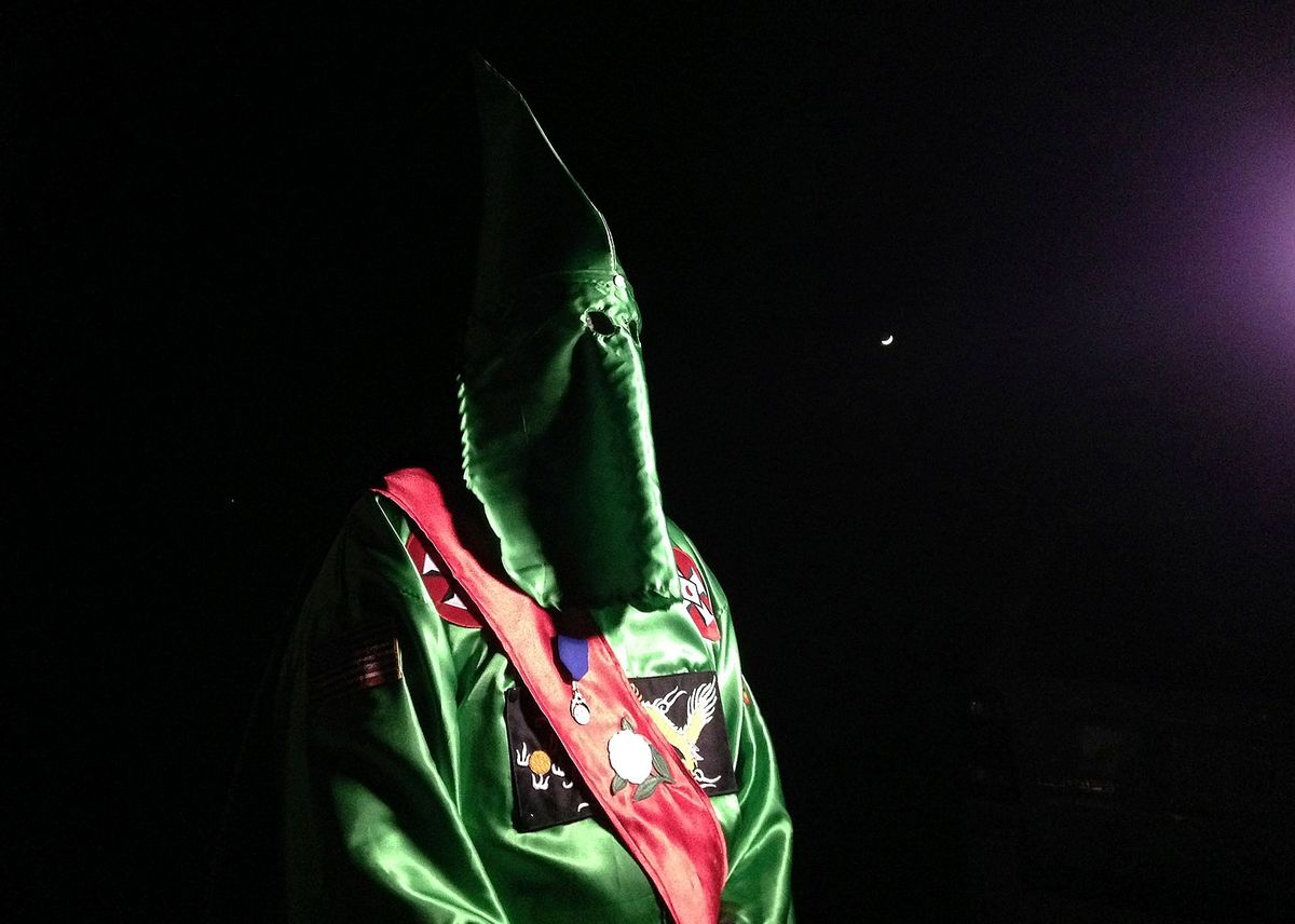 In this photo taken Friday, Dec. 2, 2016, a robed and masked Ku Klux Klansmen stands on a muddy dirt road during an interview near Pelham, N.C. The KKK and other white extremist groups don't like being called "white supremacists," a phrase that dates to the earliest days of white racist movements in the United States. () (AP Photo/Jay Reeves)