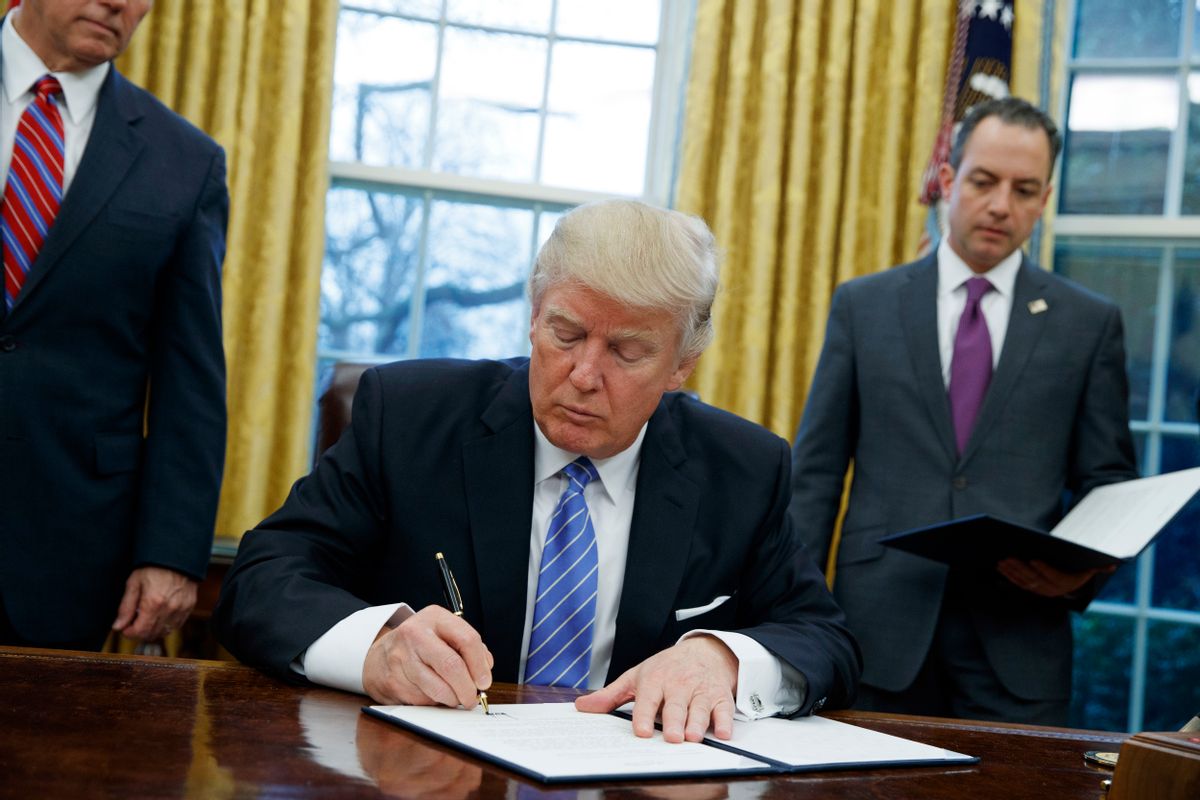 FILE - In this Jan. 23, 2017, file photo, President Donald Trump signs an executive order to withdraw the U.S. from the 12-nation Trans-Pacific Partnership trade pact agreed to under the Obama administration in the Oval Office of the White House in Washington. (AP Photo/Evan Vucci, File) (AP)